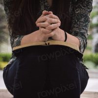 Woman praying with a bible